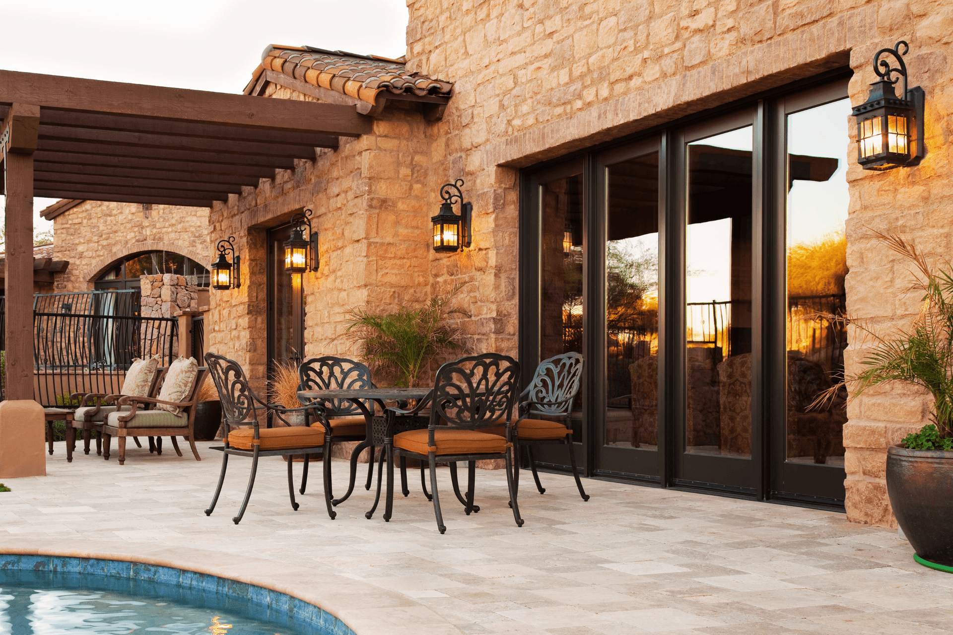 patio doors on rock home overlooking pool